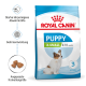 Royal Canin Puppy X-Small 2–10 Monate Tüte, Stufe 3, zeigt kleinen weiß-braunen Welpen und deutsche Symbole/Text zu Vorteilen.
