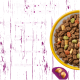 Gelbe Schüssel mit mehrfarbigem Tierfutter; lila Werbetext „Unser perfektes Versprechen“ und Aufzählungspunkte: Protein, Karotten, Erbsen