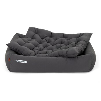 Ein plüschiges, dunkelgraues Hundebett mit gepolstertem Kissen und erhöhtem Rand, mit dem Logo "Doctor Bark" an der Seite.