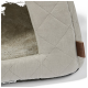 Een gezellig, beige huisdierbed met een gewatteerde buitenkant en een zachte, pluche binnenkant, met een klein leren label dat 'MORE' leest.