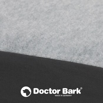 Nahaufnahme eines silbernen Reißverschlusses auf einem schwarzen Stoff, der die Zähne und den Ziehgriff zeigt, mit einem strukturierten Hintergrund.