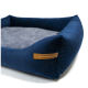 Marineblaue Haustierbett mit einem weichen grauen Zentrum und einem Lederschild, auf dem "RexProduct.com" steht.