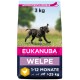 Eukanuba Hundefutter für Welpen, 3 kg, mit einem rennenden schwarzen Welpen auf einem grasbewachsenen Feld, beschriftet mit "Welpe" und Altersbereich 1-12 Monate.