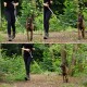 Eine Frau in schwarzen Leggings und einem langärmeligen Oberteil führt einen glücklichen, gestromten Hund an der Leine durch ein grünes Waldgebiet.