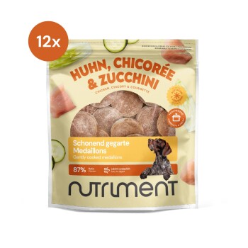 Pack mit Hundefutter-Medaillons mit Huhn, Chicorée und Zucchini, beschriftet mit "87% Huhn" und "Sanft gegarte Medaillons."