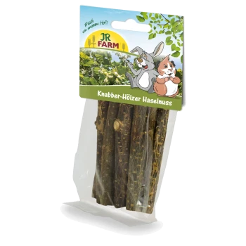Clear plastic package of hazelnut sticks for pets, labeled "Knabber-Hölzer Haselnuss," featuring a cartoon rabbit and hamster.