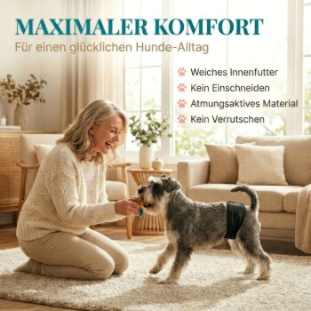 Lächelnde Frau kniet und gibt einem kleinen Hund in schwarzer Windel ein Leckerli; großer Text 'MAXIMALER KOMFORT' sichtbar.