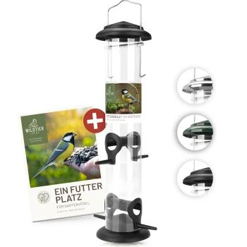 Ein Vogelhaus mit einem transparenten Rohr und schwarzem Sockel, mit einem Etikett, das "WILDTIER LIEBE" und "EIN FUTTER PLATZ FÜR GARTENVÖGEL" liest.