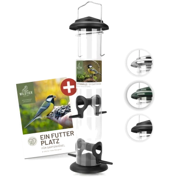 Ein Vogelhaus mit einem transparenten Rohr und schwarzem Sockel, mit einem Etikett, das "WILDTIER LIEBE" und "EIN FUTTER PLATZ FÜR GARTENVÖGEL" liest.