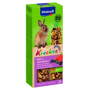 Ein brauner Kaninchen neben einer Box mit Vitakraft Kräcker, die Wildbeeren und Holunderleckereien enthält, mit den Aufschriften 'Vitamins & Minerals' und 'Zuckerfreies Rezept.'