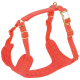 Bright orange padded dog harness with adjustable straps and gold metal buckles, no visible text.