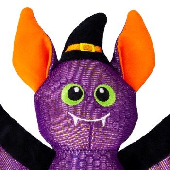 Purple bat plush toy with big orange ears, green embroidered eyes, white fangs and a black witch hat with yellow buckle