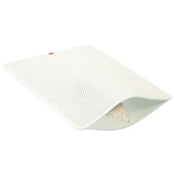 Weiches Haustierbett mit einer strukturierten Oberfläche, an einer Kante leicht eingerollt, das die weiche Füllung im Inneren zeigt.