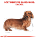 Illustration eines Dackels mit langem Körper und kurzen Beinen, mit der Beschriftung "SORTIMENT FÜR RASSEHUNDE: DACKEL" oben.