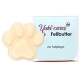 Yuki cares Fellbutter, ein pfotenförmiger Pflegebalsam für Haustiere, neben seiner Verpackung, mit dem Text 'Zur Fellpflege.'