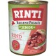 Dose Hundefutter mit der Aufschrift "RINTI Kennerfleisch Senior" mit Rindfleisch, getreidefrei, fettarm und mit Ballaststoffen, hervorgehoben auf einem bunten Hintergrund.