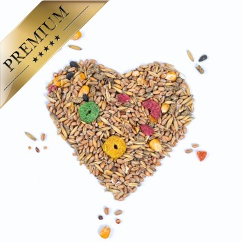 Herzförmige Anordnung verschiedener Samen und bunter Pellets, beschriftet mit "PREMIUM" in einem goldenen Banner.