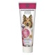 Dentifrice pour chiens dans un tube avec un Colley sur le devant, avec un texte en allemand, français et anglais sur la réduction de la plaque et du tartre.