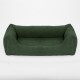 Grünes Haustierbett mit einem weichen, strukturierten Stoff und erhöhten Rändern, entworfen für Komfort und Unterstützung.