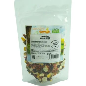 Gemüse-Mischung 100g Eine durchsichtige Tüte mit buntem getrocknetem Gemüse für kleine Haustiere, beschriftet "Gemüse Mischung" mit Nährwertangaben und Frischegarantie.