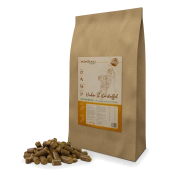 Hundfuttertüte, beschriftet mit "Huhn & Kartoffel" mit einem Gewicht von 10 kg, mit verstreuten Kroketten davor.