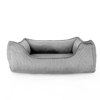 Hundebett ANTON Cord Grau M Graues gestreiftes Haustierbett mit erhöhten Rändern, das ein weiches Innenleben und ein kleines Etikett mit der Aufschrift 'PAW NOW' hat.