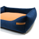 Marineblaues Haustierbett mit einem weichen orangefarbenen Zentrum und erhöhten Rändern, mit einem Lederschild, auf dem "RexProduct.com" steht.