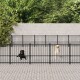 Zwei Hunde, ein schwarzer Labrador und ein gelber Labrador, stehen innerhalb eines schwarzen Metallzauns in einem Haustiergehege, umgeben von Grün.