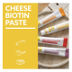 Katzenpastentuben auf einem Teller neben einem gelben Feld mit der Aufschrift CHEESE BIOTIN PASTE.