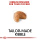 Kibble designed for cocker spaniels, featuring a unique, curved kibble shape with the text "TAILOR-MADE KIBBLE" below.