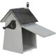 A wooden birdhouse with a gray finish, featuring a metal roof and a bird silhouette cutout on the side, has an open front.