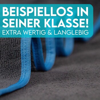Nahaufnahme einer weichen, grauen Haustierdecke mit blauen Akzenten, mit fettem Text, der lautet "BEISPIELLOS IN SEINER KLASSE! EXTRA WERTIG & LANGLEBIG."