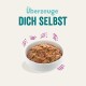 Schüssel mit Haustierfutter mit gemischten Zutaten, begleitet von dem Text "Überzeuge DICH SELBST" in einer verspielten Schriftart.