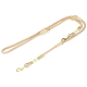 Laisse pour chien tissée beige avec fermoirs métalliques dorés et bandes décoratives vertes et blanches.