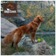 A golden retriever stands on a rocky ledge by a serene lake with autumn foliage and a green toy. Dogs Creek logo in the corner.