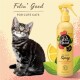 Eine getigerte Katze sitzt neben einer gelben Flasche "Pet Head Dry Clean Spray" mit Zitronenöl, umgeben von Zitronenscheiben und Blättern.