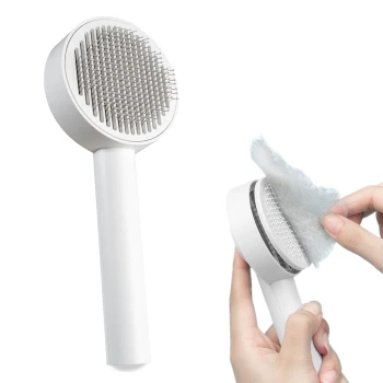 Eine weiße Haustierpflegebürste mit einem runden Kopf und Metallborsten, die verwendet wird, um Fell zu entfernen.