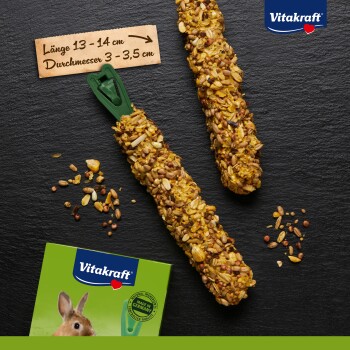 Two crunchy rabbit treats from Vitakraft, measuring 13-14 cm in length and 3-3.5 cm in diameter, with scattered seeds and a green packaging box.