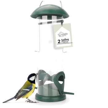 Ein grüner Vogelhäuschen mit einem transparenten Rohr und einem hängenden Haken, mit einer Kohlmeise, die am Futterhäuschen pickt. Ein Schild liest '2 Anflug Plätze.'
