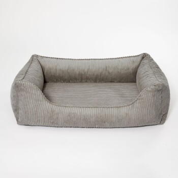 Graues Haustierbett mit einer weichen, gerippten Textur und erhöhten Kanten für Komfort, vor einem schlichten weißen Hintergrund.