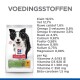 Hondenvoeding verpakking met een zwart-witte border collie, met voedingsinformatie inclusief eiwitten, vetten en vitamines.