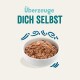 Schüssel mit Haustierfutter, bestehend aus einer Mischung aus Fleisch und Gemüse, begleitet von dem Text 'Überzeuge DICH SELBST' in fetten türkisfarbenen Buchstaben.