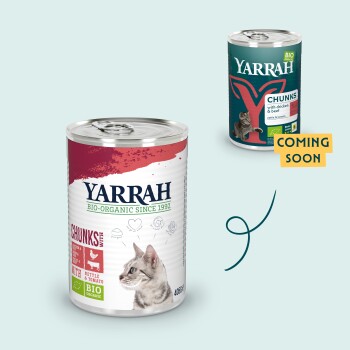 Puszki karmy dla kotów Yarrah organic: "Kawałki z kurczakiem i burakiem" oraz "Kawałki z pokrzywą i pomidorem", z ilustracją kota i etykietą "Już wkrótce".
