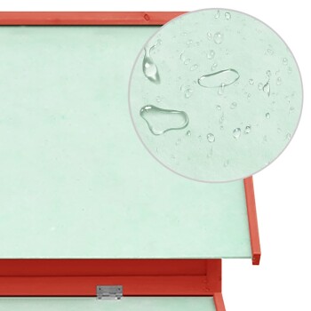 Bild eines Produkts aus einem Tiergeschäft, das ein wasserdichtes Haustierbett mit einer mintgrünen Oberfläche und einem roten Rahmen zeigt, mit Wassertropfen auf der Oberfläche.