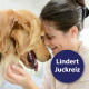 Frau lächelt, Stirn an Stirn mit einem Golden Retriever; ein blauer Kreis trägt die Aufschrift 'Lindert Juckreiz'.