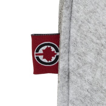 Nahaufnahme eines grauen Haustierprodukts mit einem roten Etikett, das ein schwarzes Kreis- und ein weißes Ahornblatt-Design zeigt.